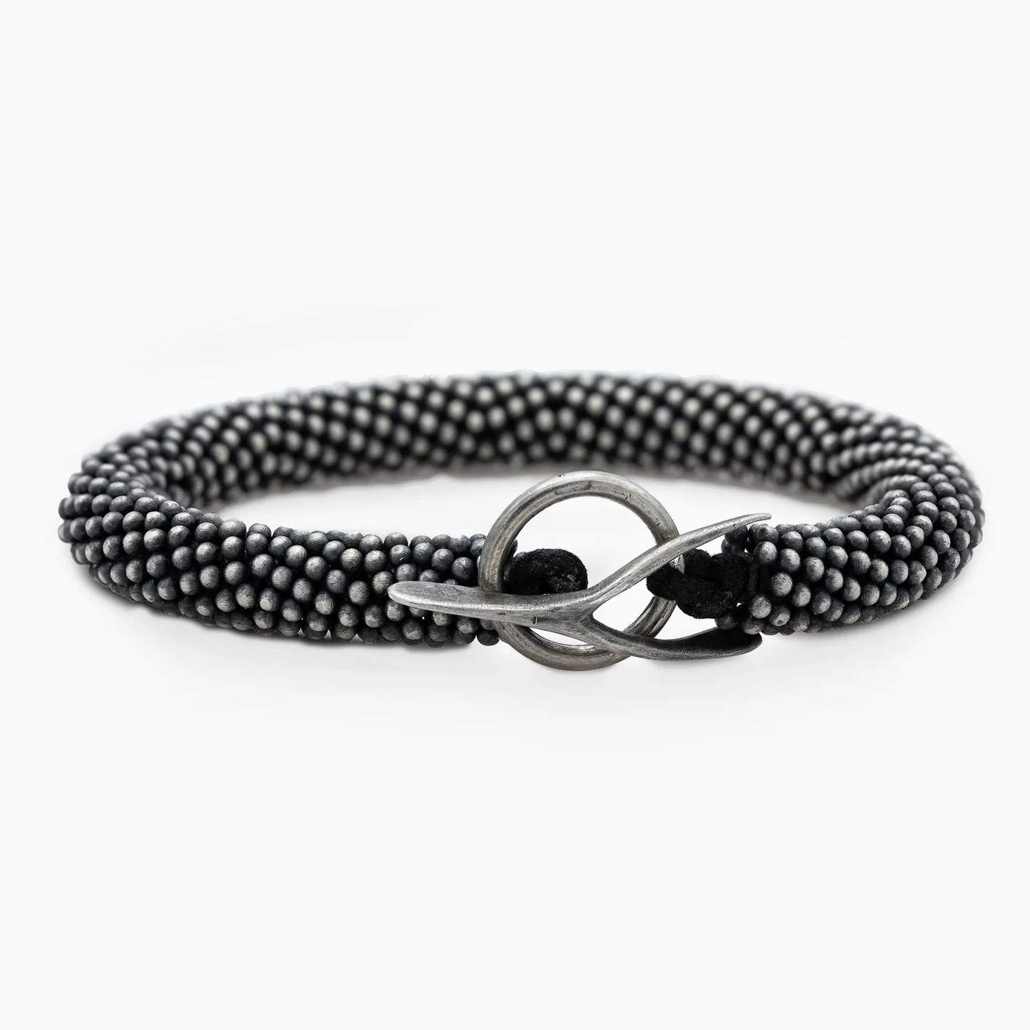 Textured black bracelet with a silver wishbone clasp, featuring a bold, unisex design.