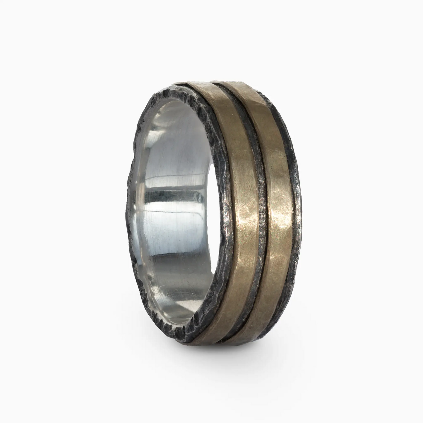 Silver and brass ring with parallel lines and rugged edges.