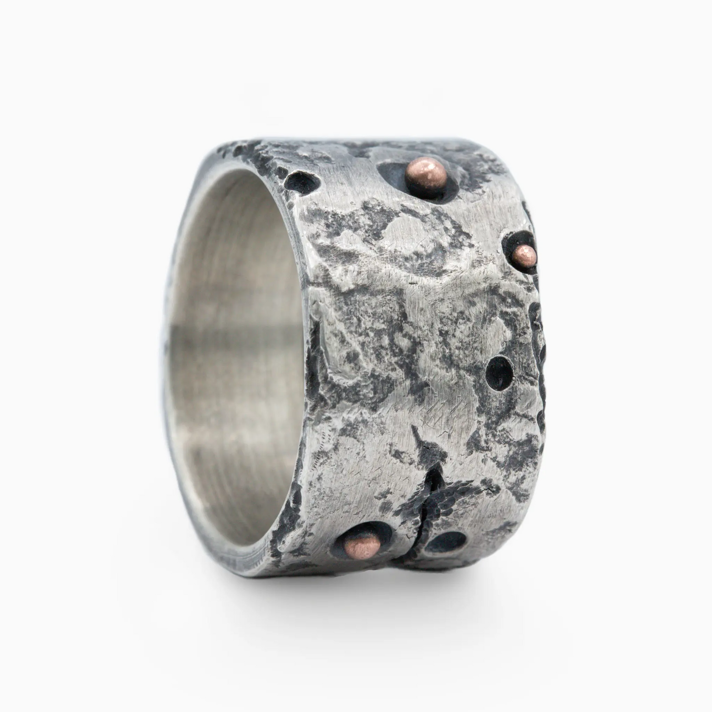 Detailed view of the ISRT+ silver ring with textured surface, unique cracks, and copper accents, highlighting artistic style.