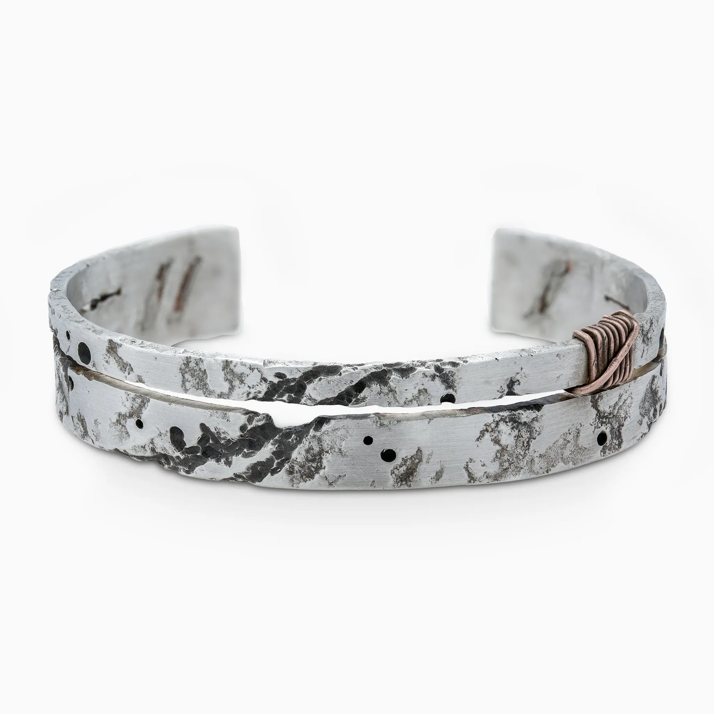 Handcrafted silver bracelet with unique textured design.