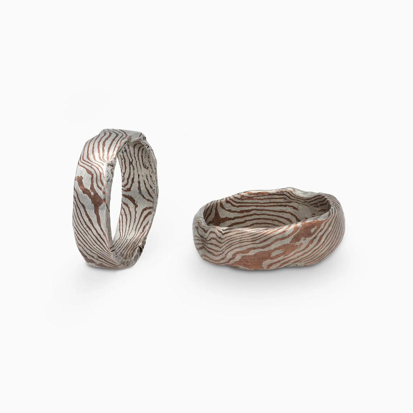 Sterling silver two Moku Rings side by side, showcasing unique woodgrain-inspired designs.