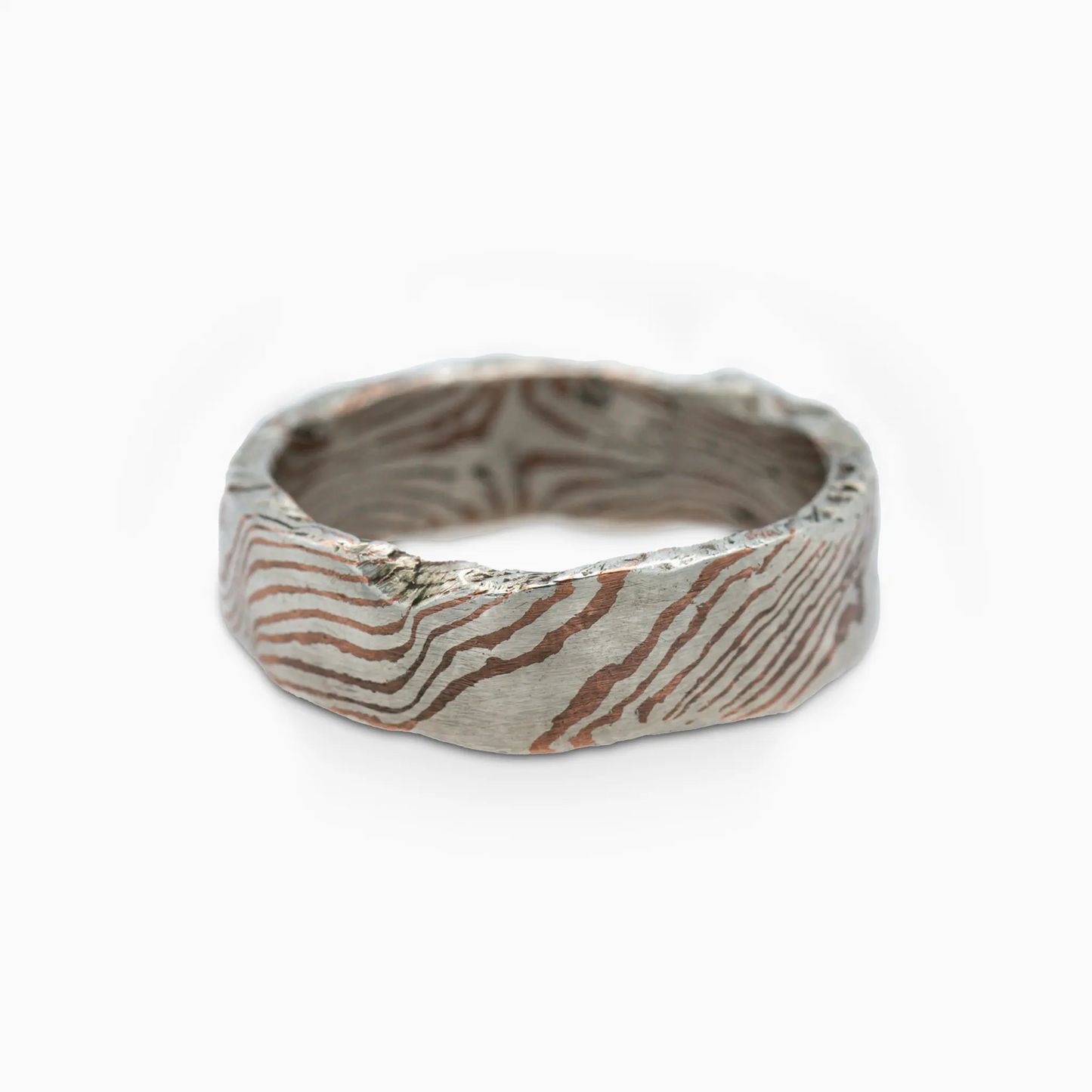 Sterling silver close-up of the Moku Ring, showcasing intricate woodgrain design using the mokume-gane technique.