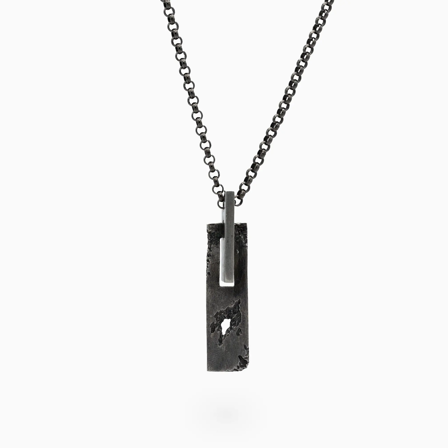 SW-0801 pendant in silver on a chain, featuring contrasting light and dark parts.
