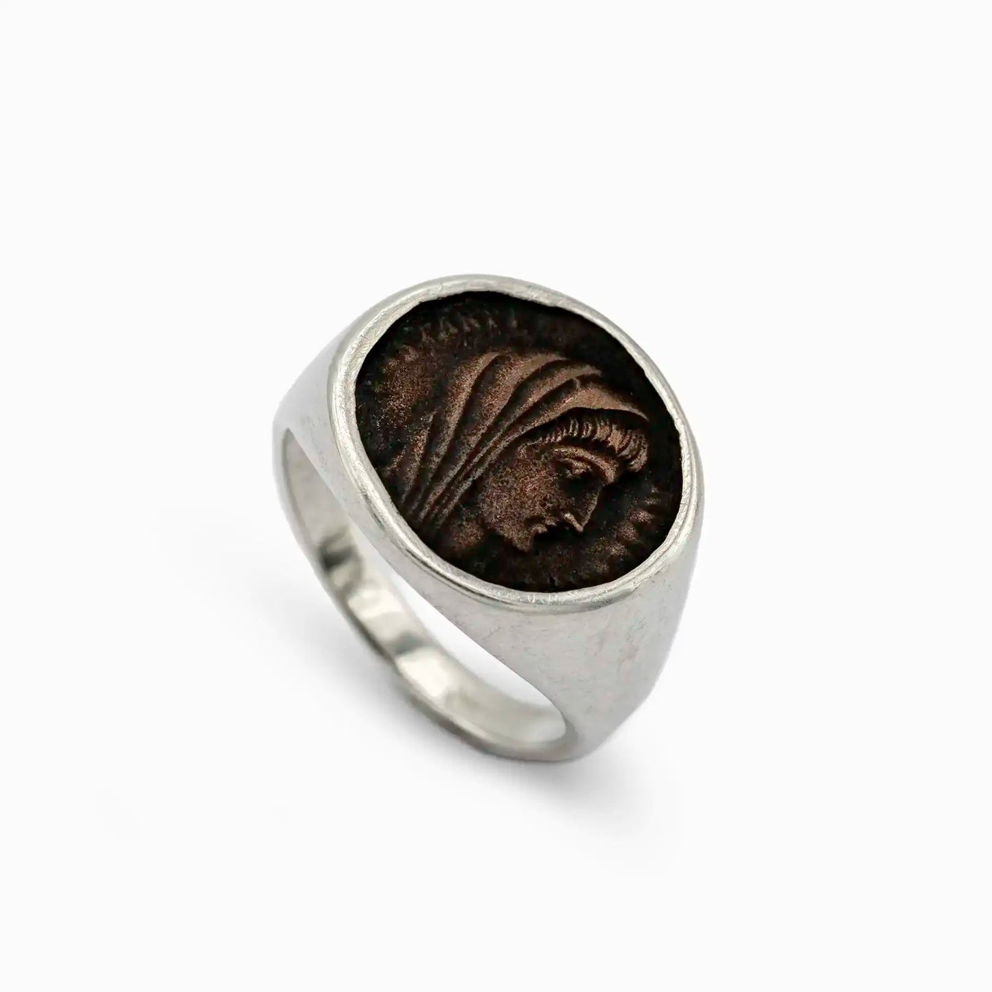 Silver signet ring with dark bronze coin depicting a hooded profile in fine relief.