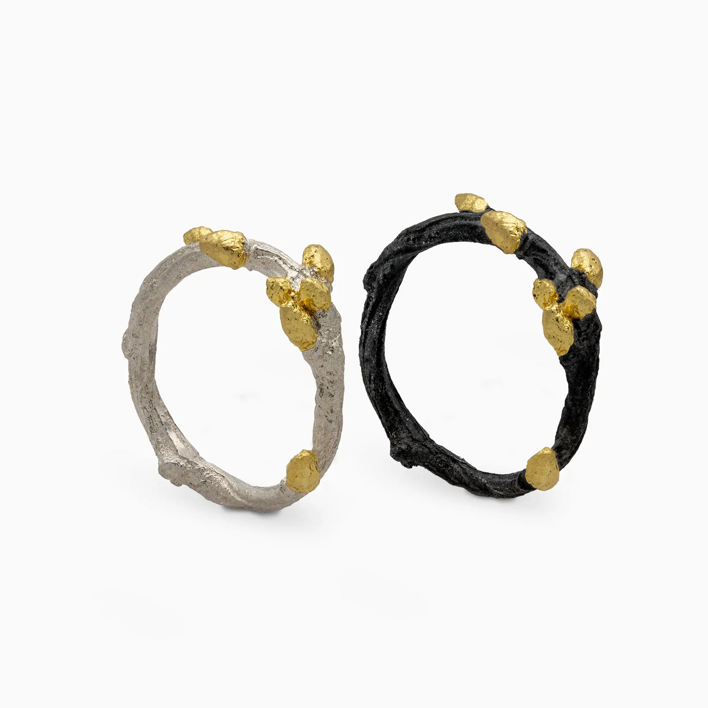 Two Bonsai rings in sterling silver and black with gold vermeil accents, featuring a nature-inspired design.