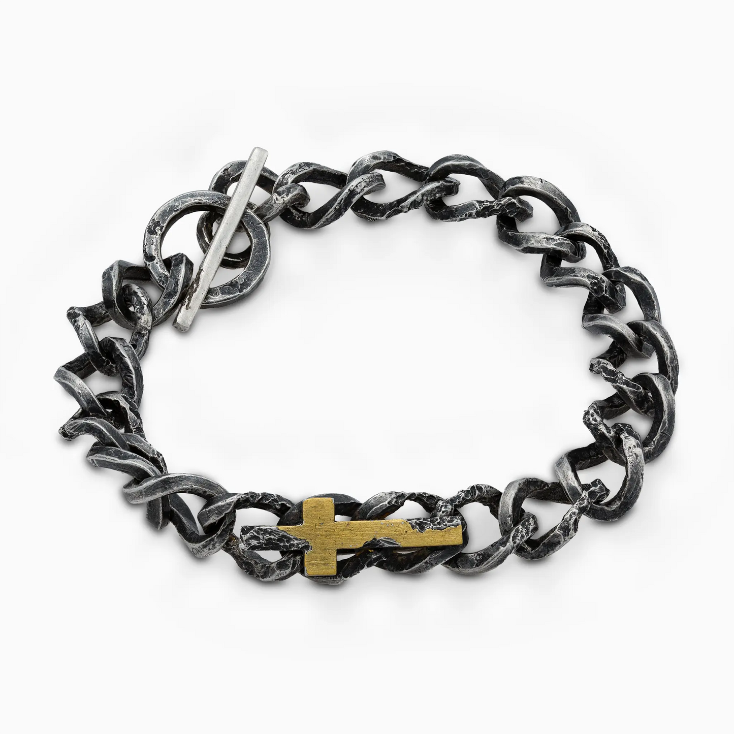 Close-up of a rugged silver bracelet with toggle clasp and gold cross detail.