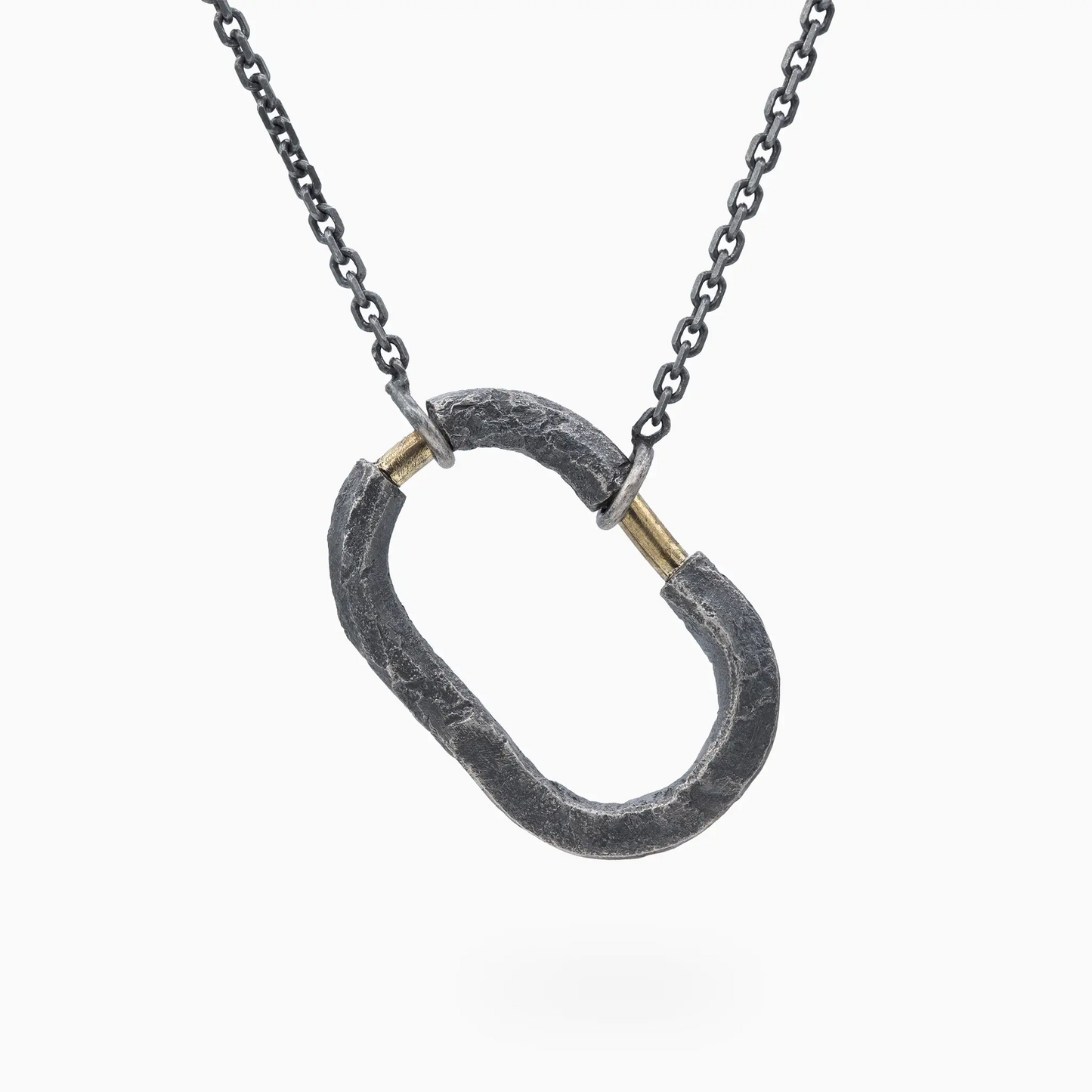 Sterling Silver oxidized silver pendant with gold accents, combining rough textures and refined craftsmanship.