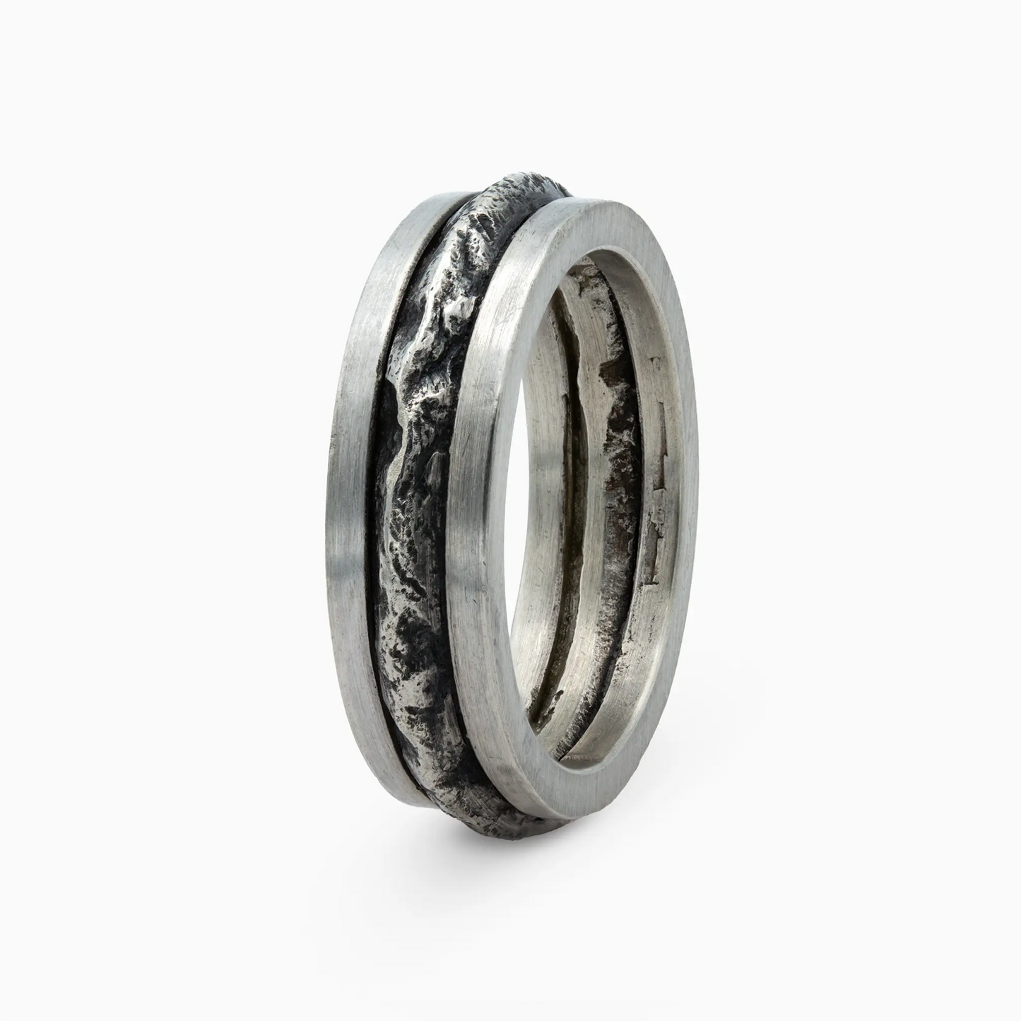 Sterling Silver close-up of a silver ring with a bold, textured band inspired by rugged mountain terrain.