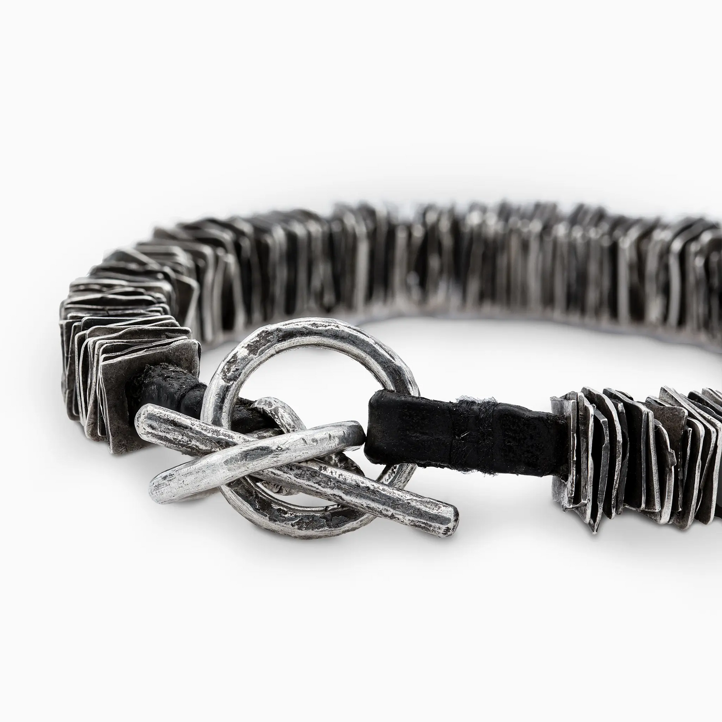 Sterling silver close-up of the 'Plates' bracelet's rugged toggle clasp.