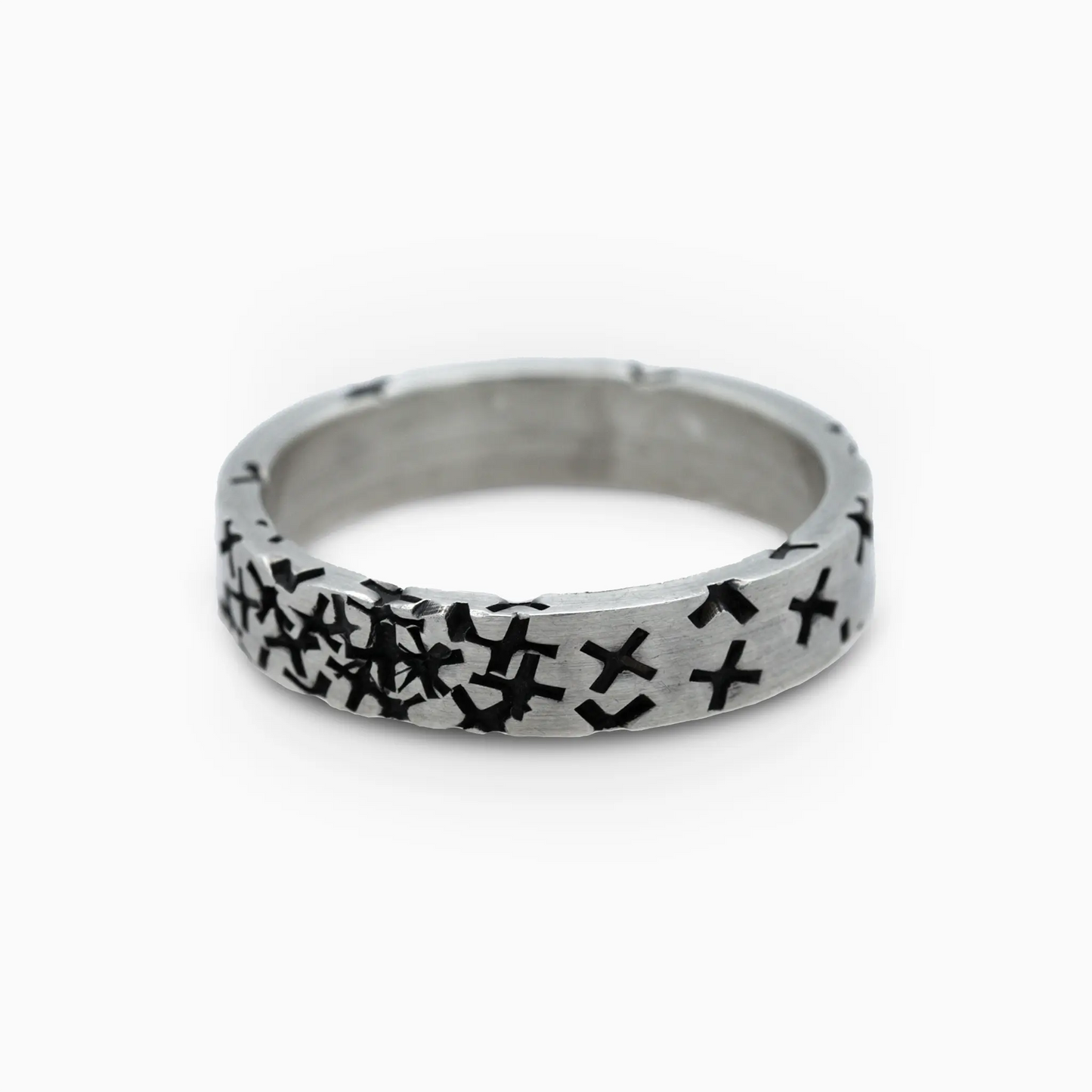 Silver ring with black cross patterns across the band.