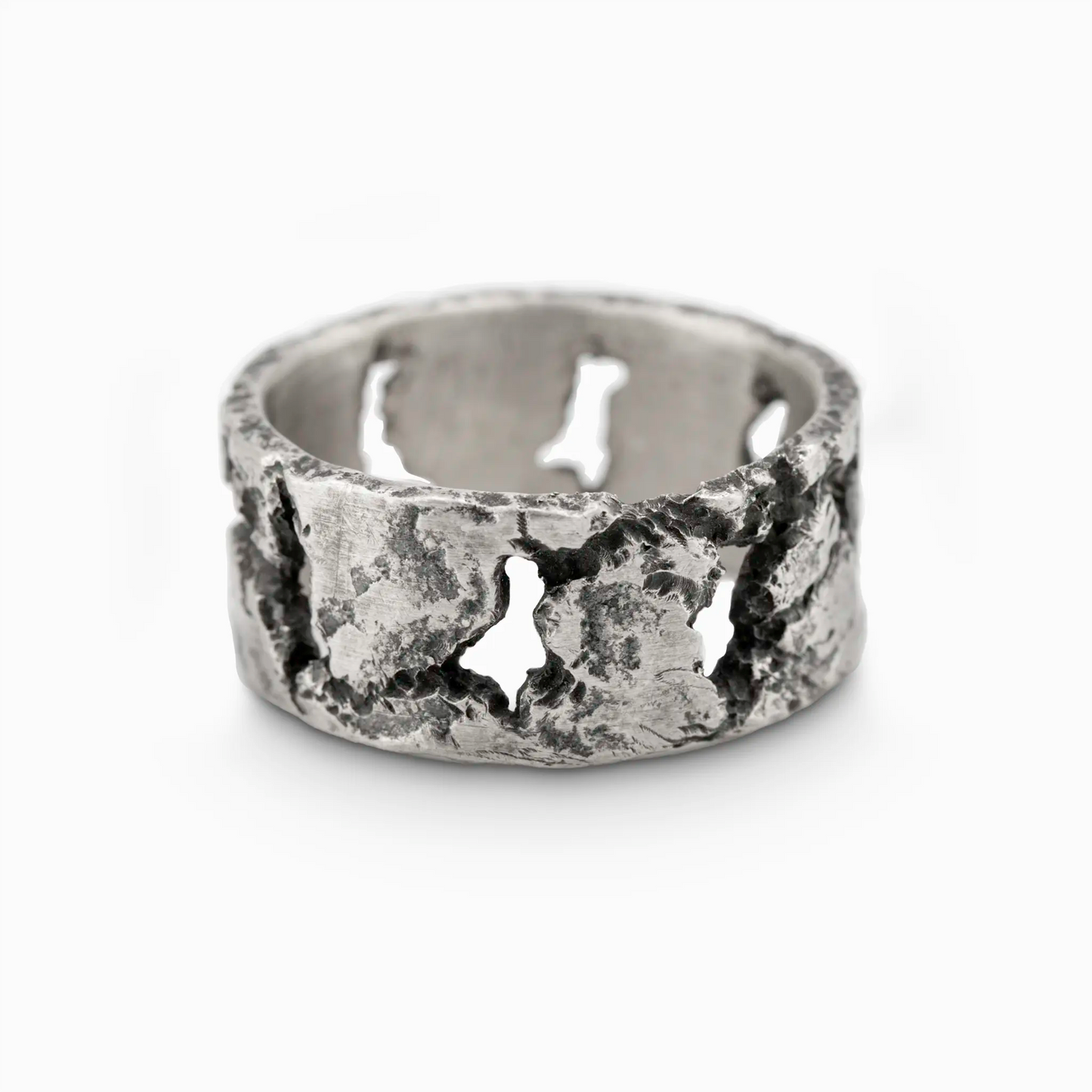 Silver band ring with a distressed, uneven surface and randomly shaped cutout patterns.