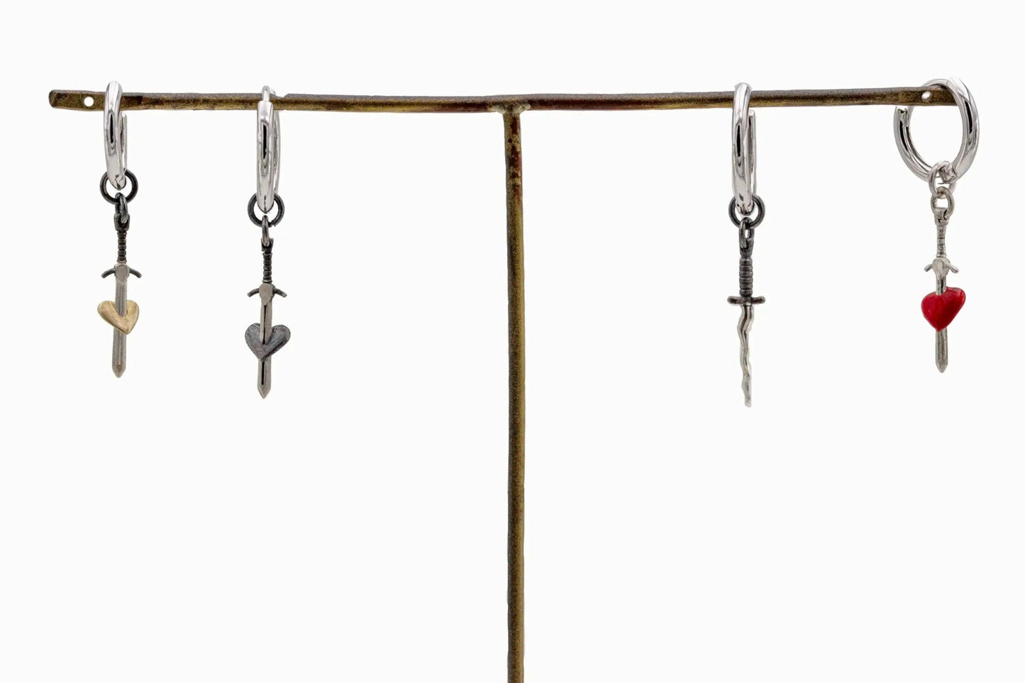 Set of four sterling silver hoop earrings with gold heart sword, black heart sword, wavy sword, and red heart sword pendants