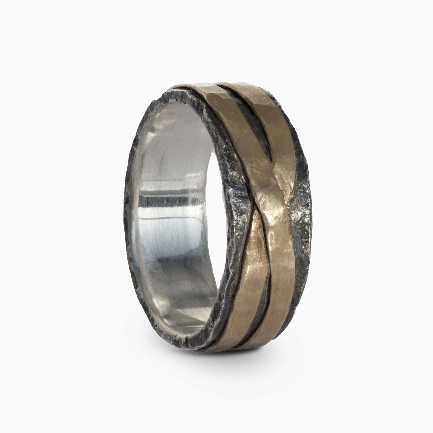 Silver and brass ring featuring intersecting lines and rough textures. A unique design symbolizing unity and timeless style.