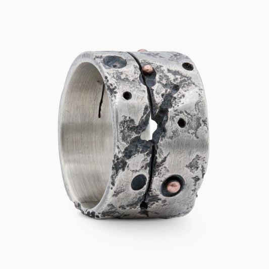 Bold silver ring with rugged textures, organic cracks, and copper accents. A striking design blending raw elegance with modern craftsmanship.