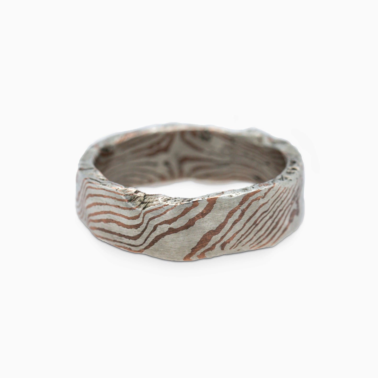 Close-up of the Moku Ring, capturing the intricate, organic woodgrain design crafted with the traditional mokume-gane technique.