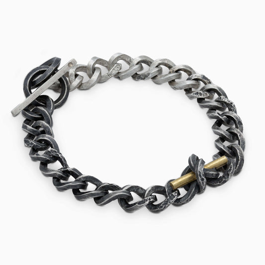 The Staff and Chain bracelet displayed flat, highlighting its rugged elegance with a harmonious blend of silver and gold elements, crafted to inspire resilience.