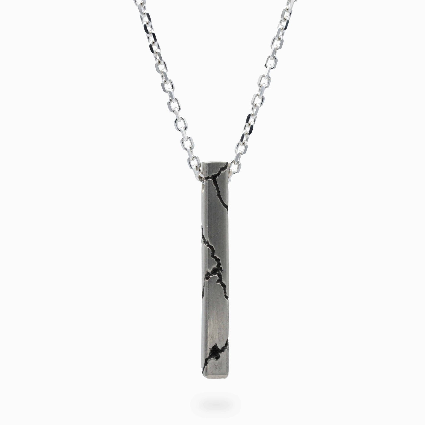 A contemporary lightning-themed pendant with bold textured details, featured on a light silver chain. Its sleek design celebrates modern artistry and timeless style.