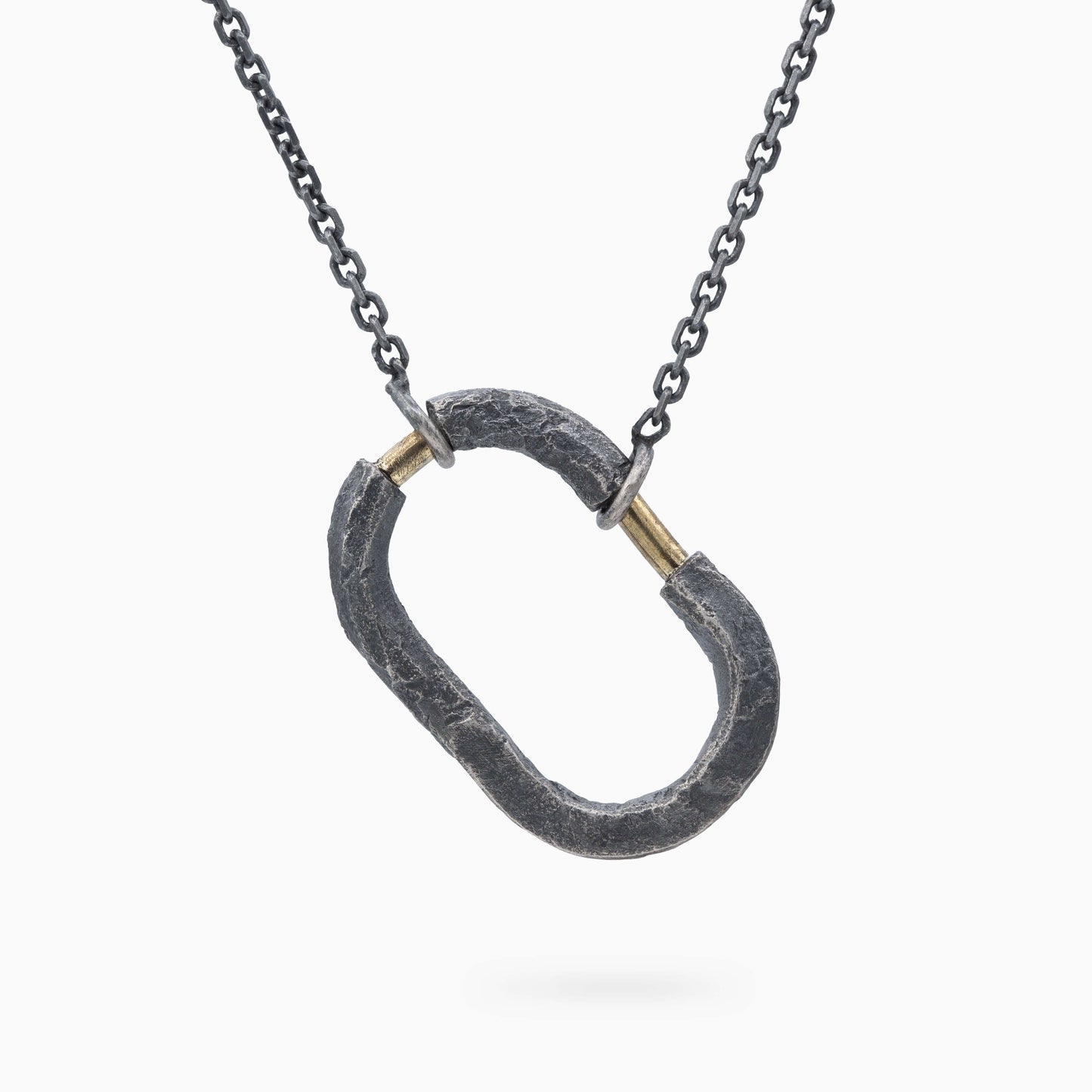 Elegant oxidized silver pendant with gold accents, blending rough textures and refined craftsmanship for a timeless, meaningful look.