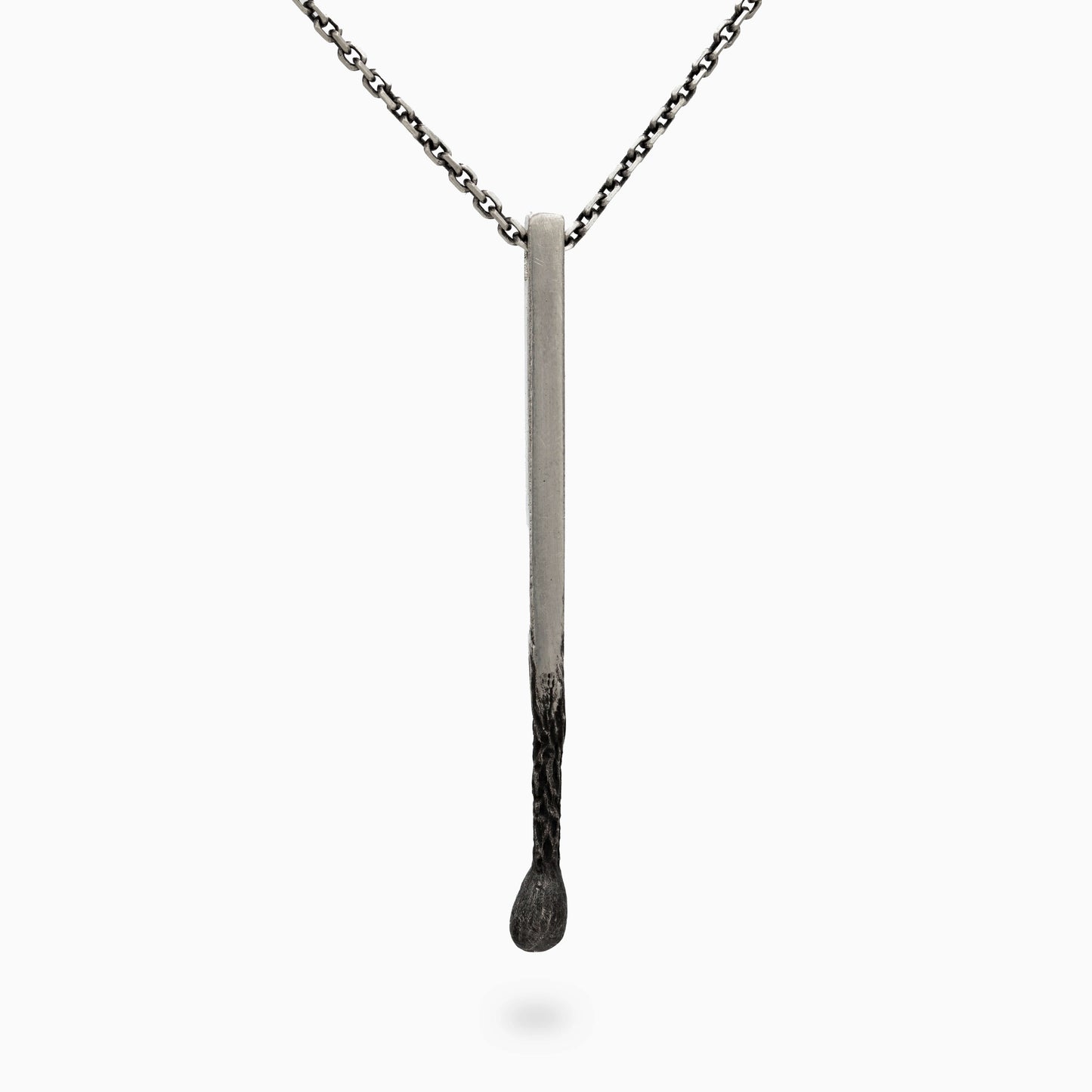 Minimalist silver matchstick pendant with a sleek, clean design. A refined accessory embodying elegance and individuality.