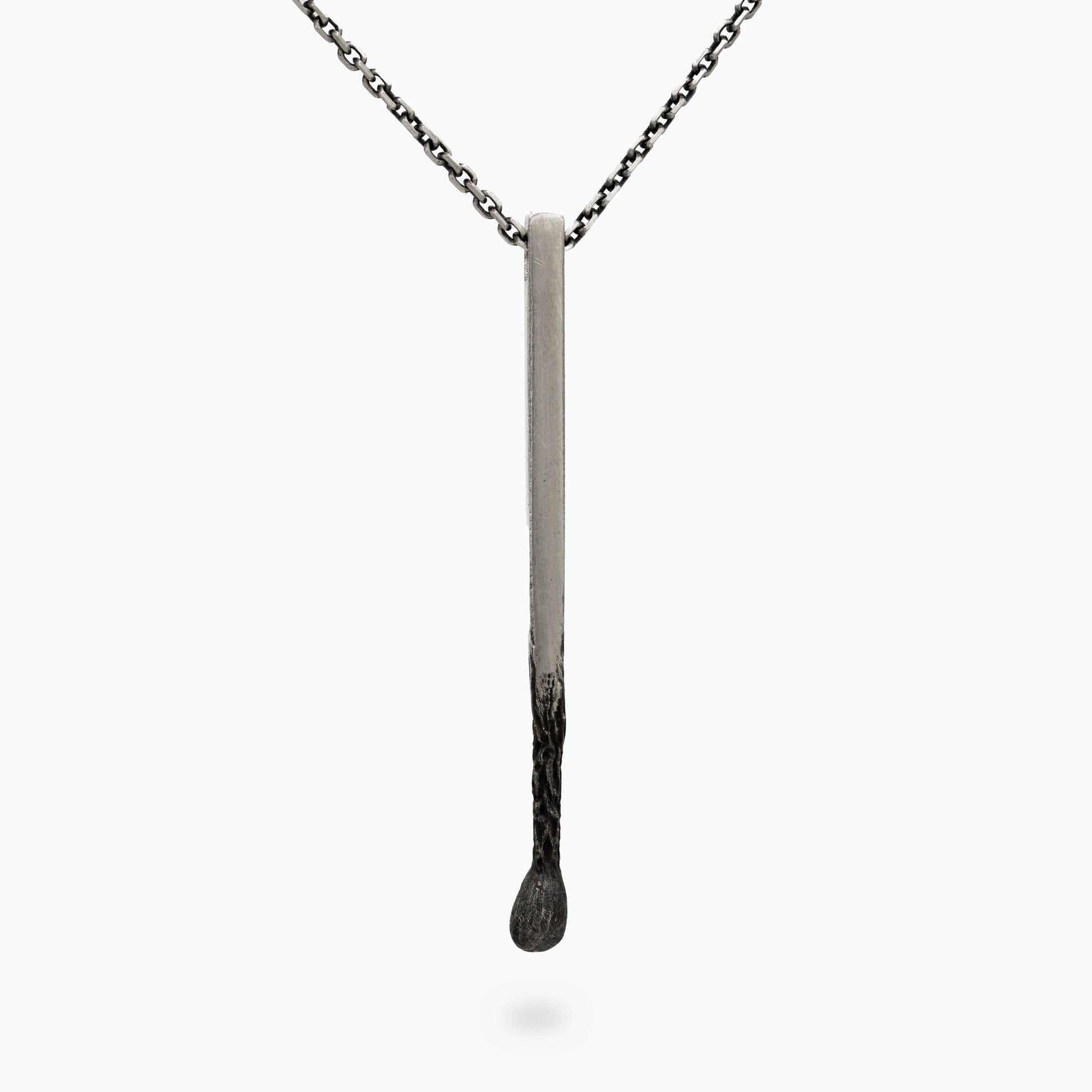 Minimalist silver matchstick pendant with a sleek, clean design. A refined accessory embodying elegance and individuality.