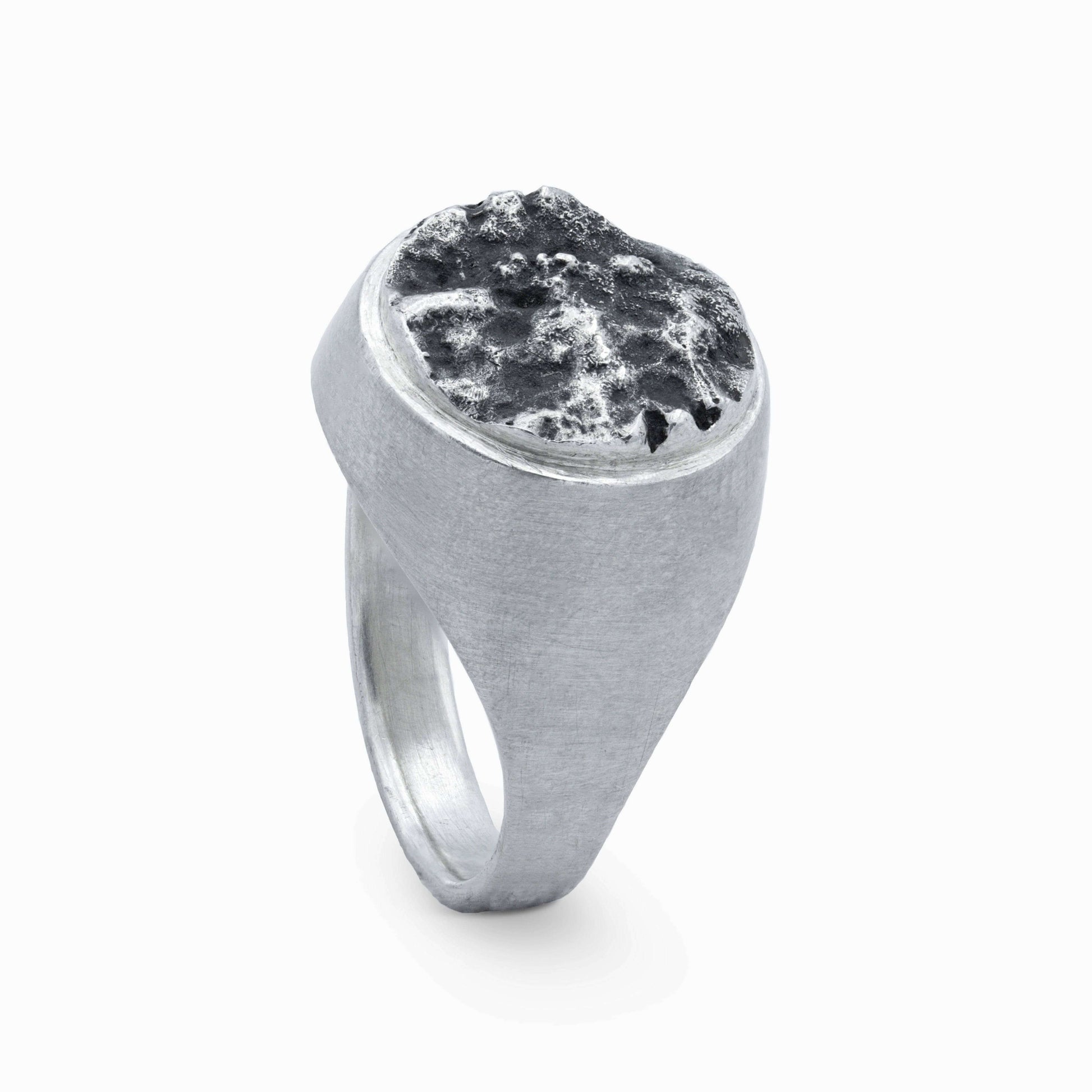 Moon-inspired silver ring with a rugged textured top, reminiscent of lunar landscapes.