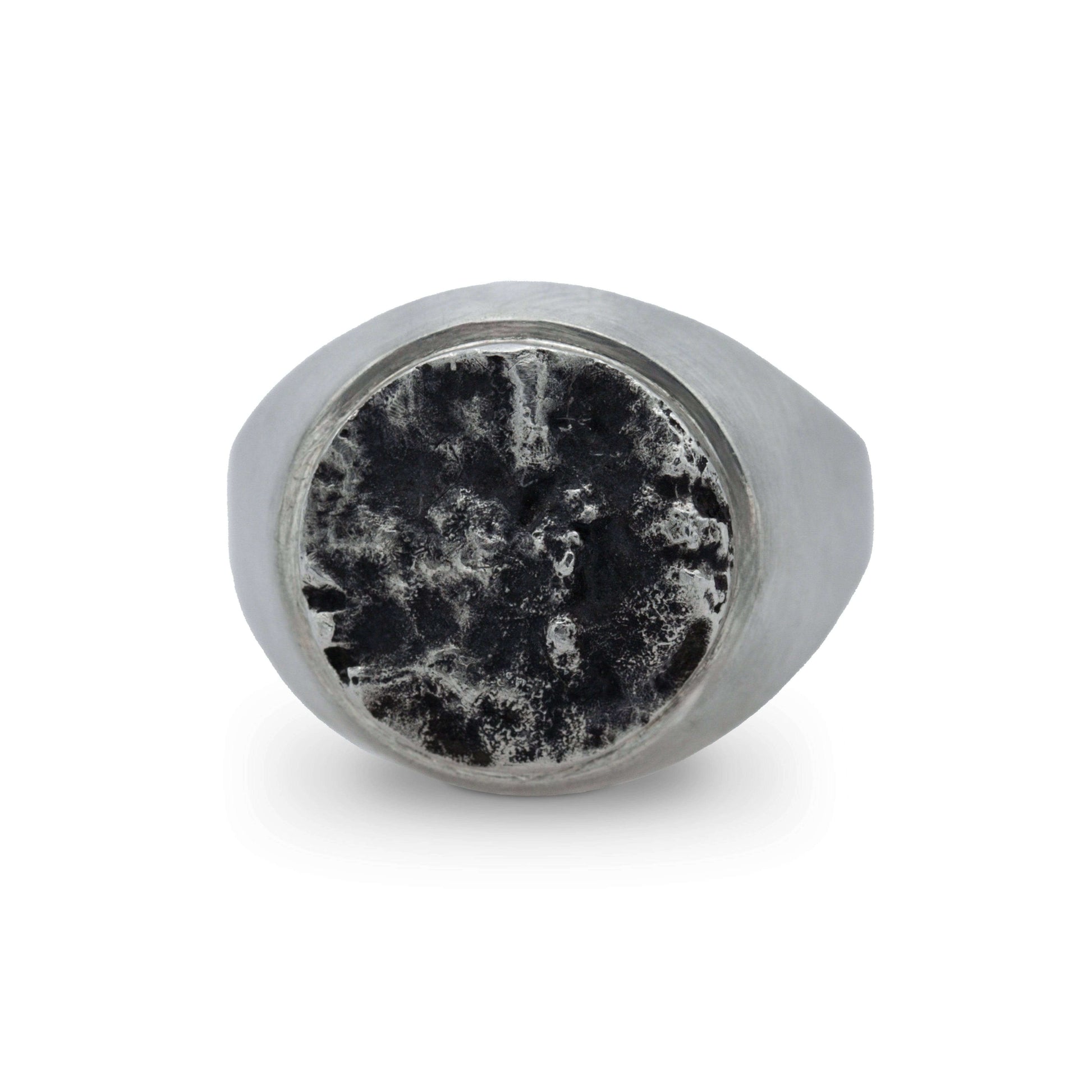 Front-facing view of a textured silver ring, showcasing its unique moon surface-inspired design.