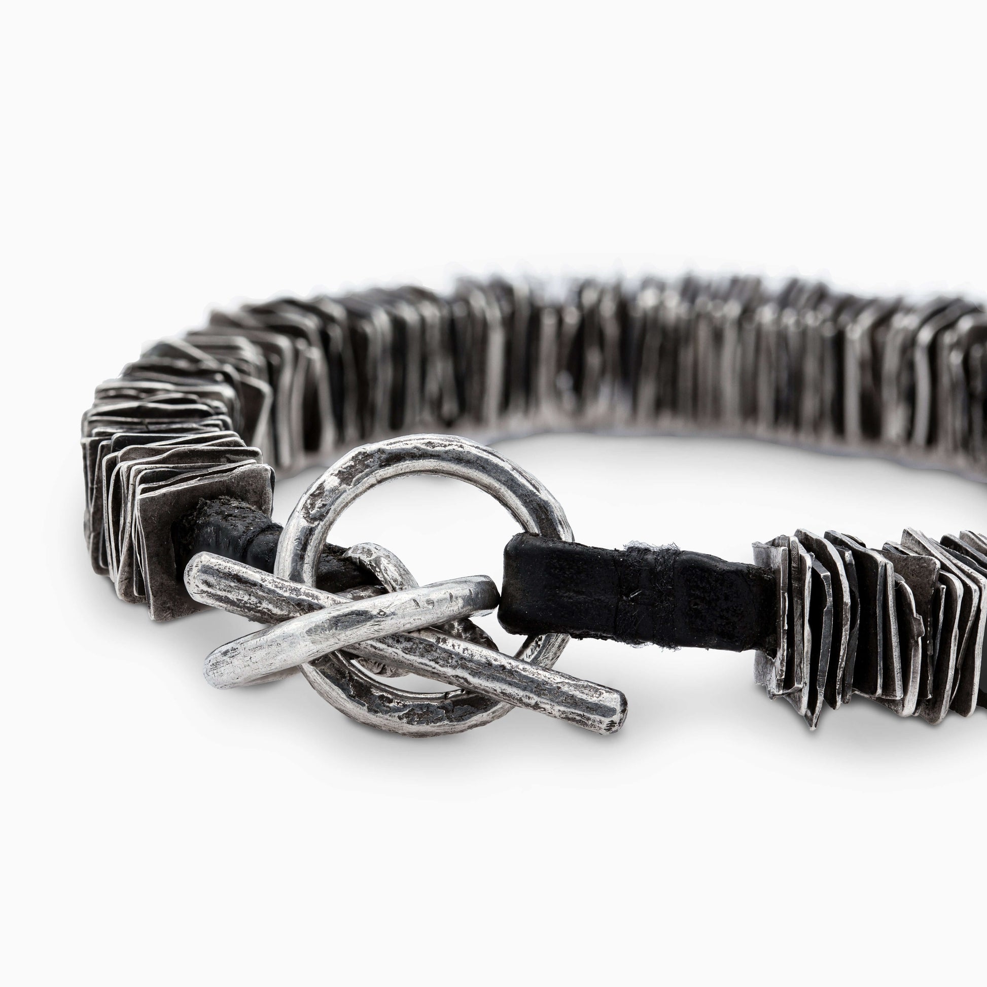 Detailed view of the rugged toggle clasp of the 'Plates' bracelet, blending functionality with artisanal charm.