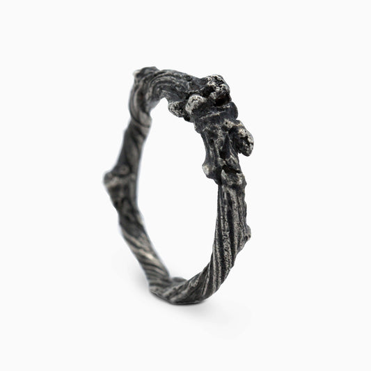 A front view of the sculptural, twig-like ring, highlighting its natural grooves and raw beauty. The unique design radiates a sense of timeless artistry, perfect for personal expression.